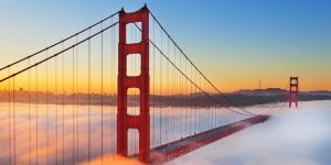 Golden Gate Bridge above fog at sunrise